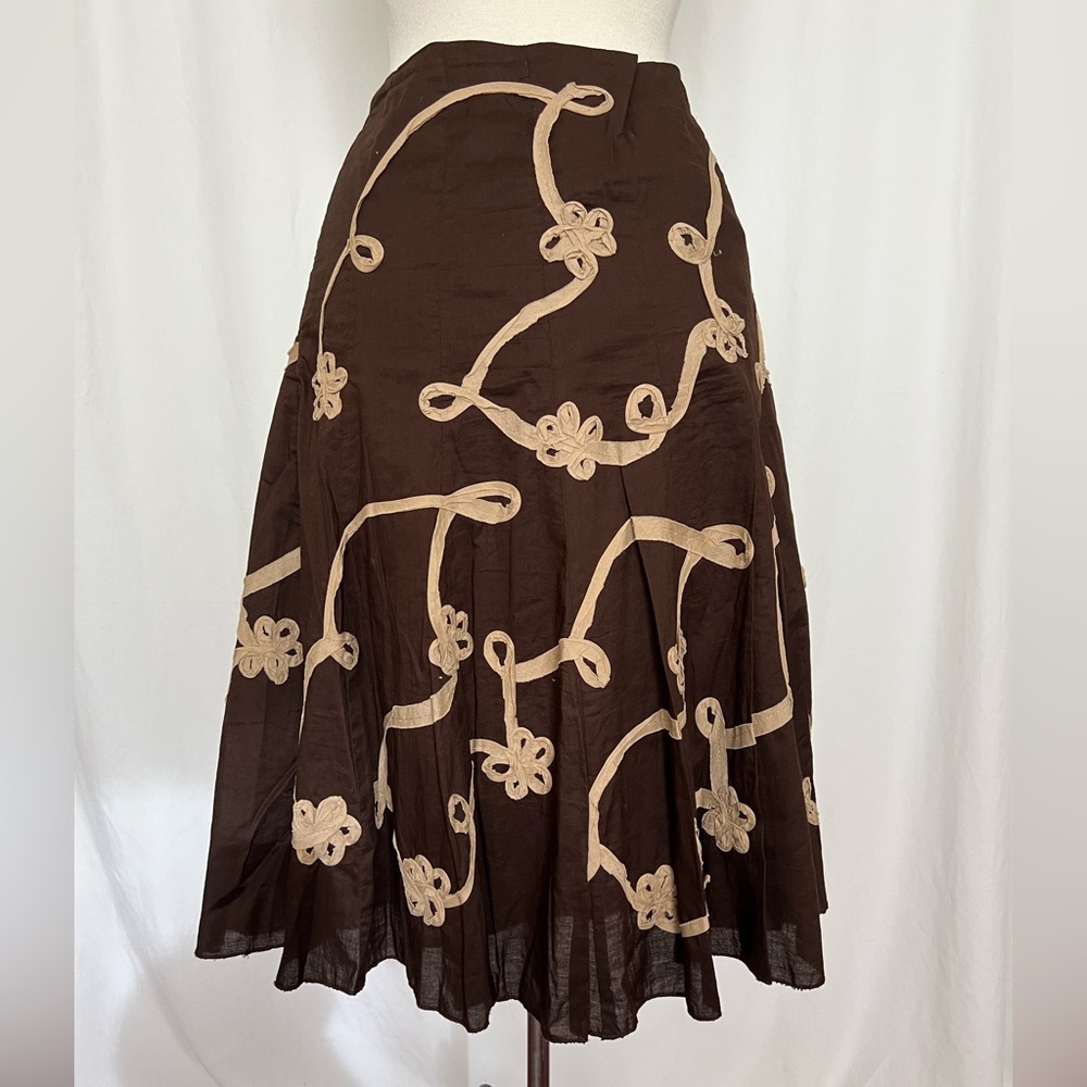 Brown skirt with cream colored ribbon trim.